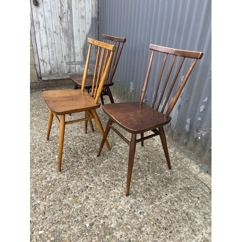 143 - Three Ercol stick back chairs