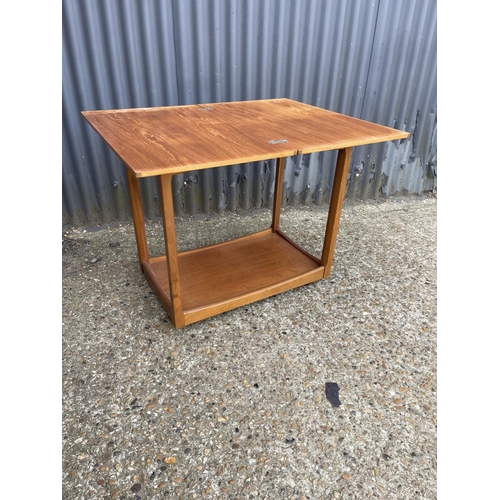 149 - A mid century teak tea trolley with fold over top