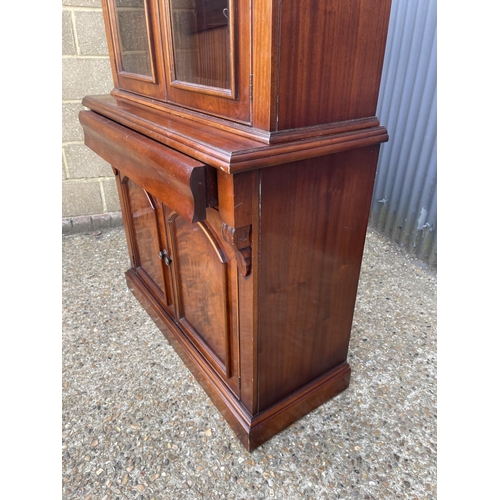 169 - A reproduction mahogany bookcase cupboard  110x50x208