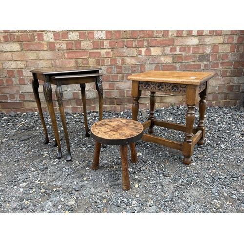 19 - A carved oak occasional table, nest of two and a three legged stool