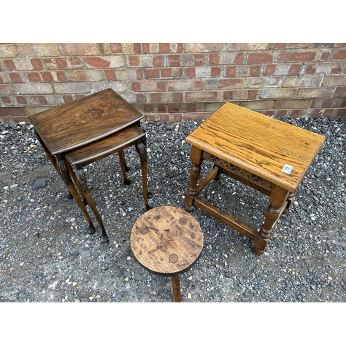 19 - A carved oak occasional table, nest of two and a three legged stool