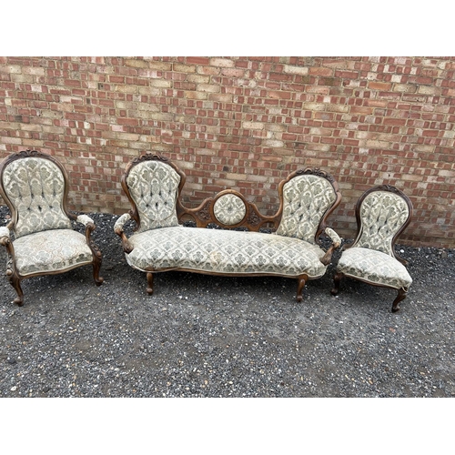 22 - A Victorian walnut framed three piece salon suite consisting of settee, ladies chair and a gents arm... 