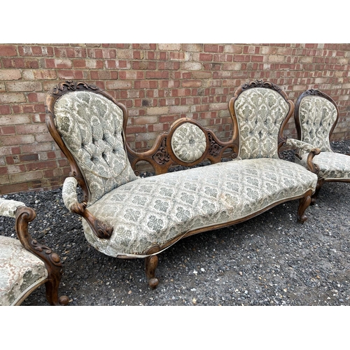 22 - A Victorian walnut framed three piece salon suite consisting of settee, ladies chair and a gents arm... 