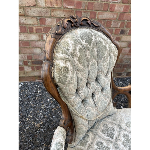 22 - A Victorian walnut framed three piece salon suite consisting of settee, ladies chair and a gents arm... 