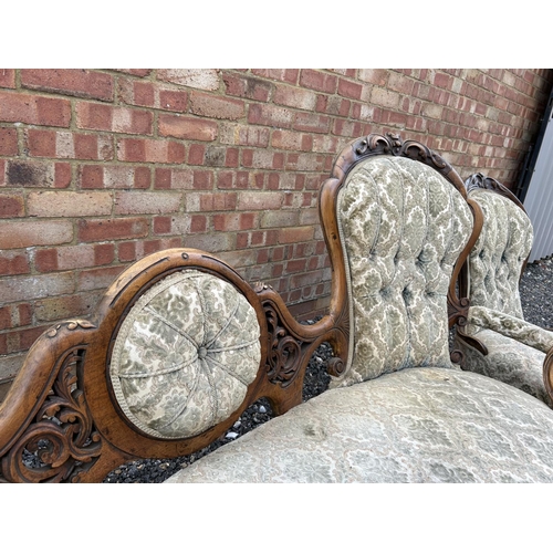 22 - A Victorian walnut framed three piece salon suite consisting of settee, ladies chair and a gents arm... 