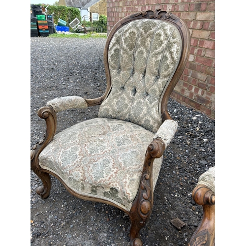 22 - A Victorian walnut framed three piece salon suite consisting of settee, ladies chair and a gents arm... 