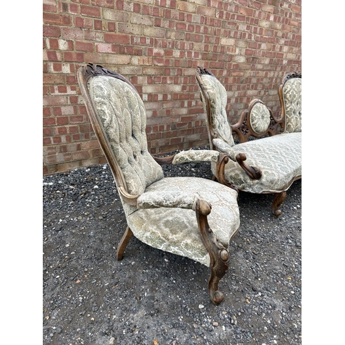 22 - A Victorian walnut framed three piece salon suite consisting of settee, ladies chair and a gents arm... 