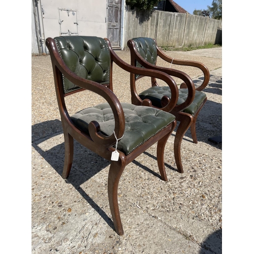 225 - A pair of chesterfield green leather office chairs