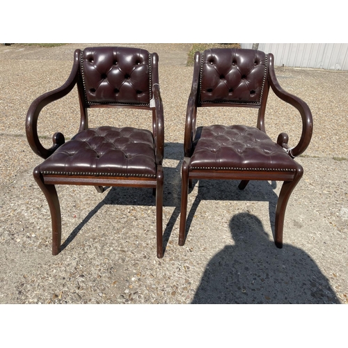 226 - A pair of chesterfield brown leather office chairs