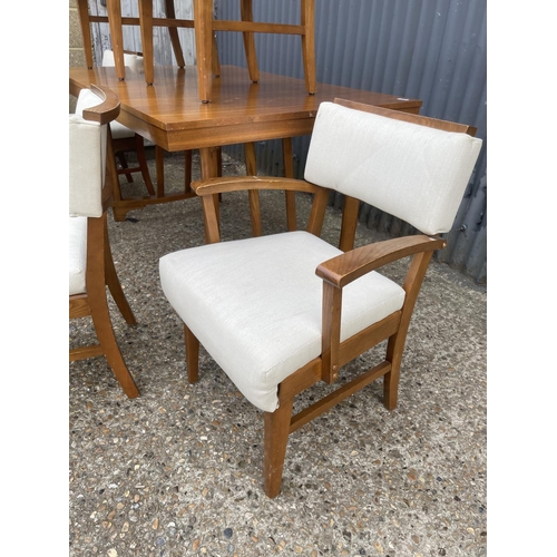 255 - A 1950' walnut extending dining table together with six chairs