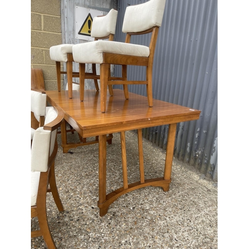 255 - A 1950' walnut extending dining table together with six chairs