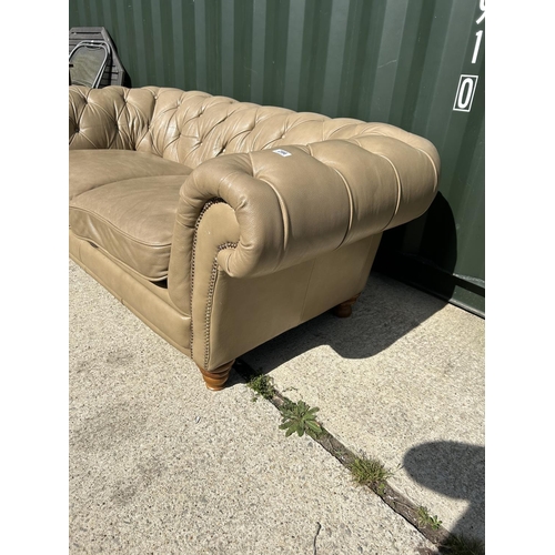 286 - A golden brown leather chesterfield club style sofa