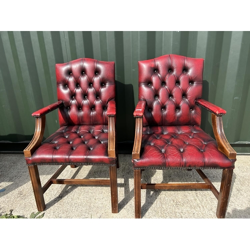 292 - A pair of oxblood red leather chesterfield Gainsborough chairs