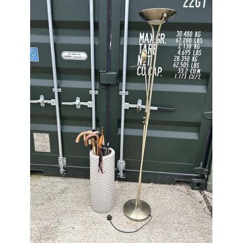 299 - A ceramic umbrella stand AF with sticks together with a floor lamp