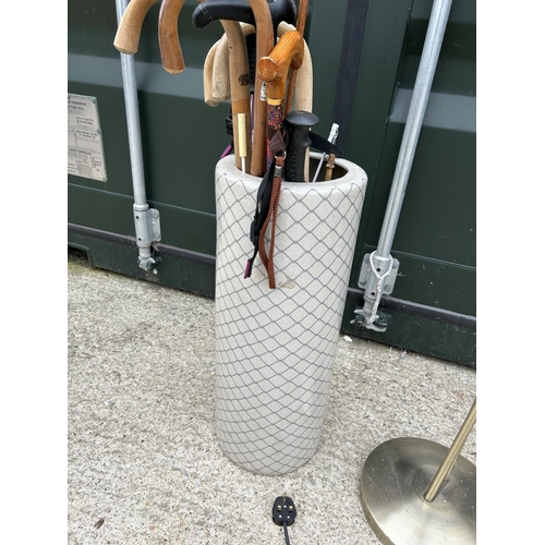 299 - A ceramic umbrella stand AF with sticks together with a floor lamp