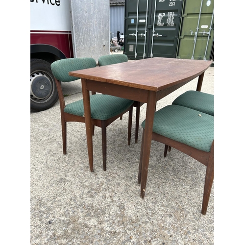 300 - A mid century teak extending dining table together with four matching chairs