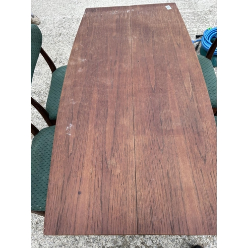 300 - A mid century teak extending dining table together with four matching chairs