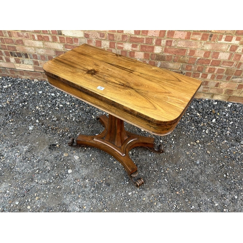 33 - A Victorian rosewood fold over card table with green baize