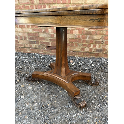 33 - A Victorian rosewood fold over card table with green baize