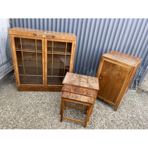 52 - A glazed walnut two door bookcase together with a walnut record cupboard and a walnut nest of three ... 