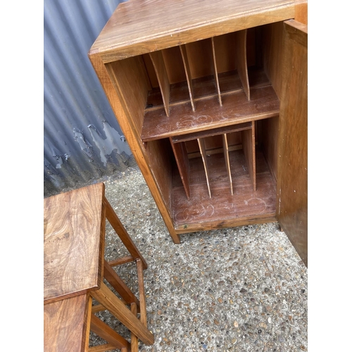 52 - A glazed walnut two door bookcase together with a walnut record cupboard and a walnut nest of three ... 