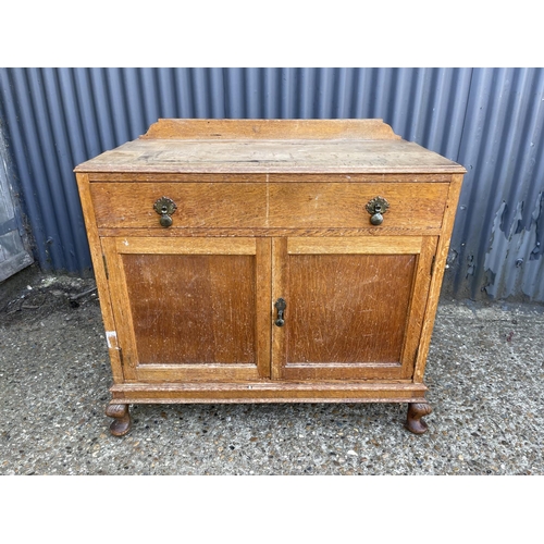 57 - A single drawer oak cupboard