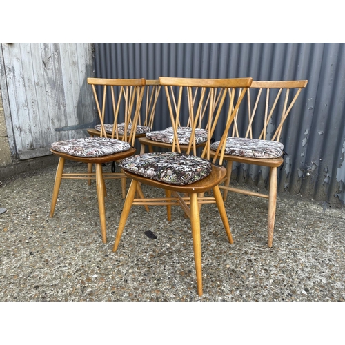 68 - A matched set of five Ercol stick back chairs (three with straight stretchers, two with cross cross ... 