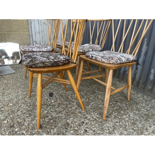 68 - A matched set of five Ercol stick back chairs (three with straight stretchers, two with cross cross ... 