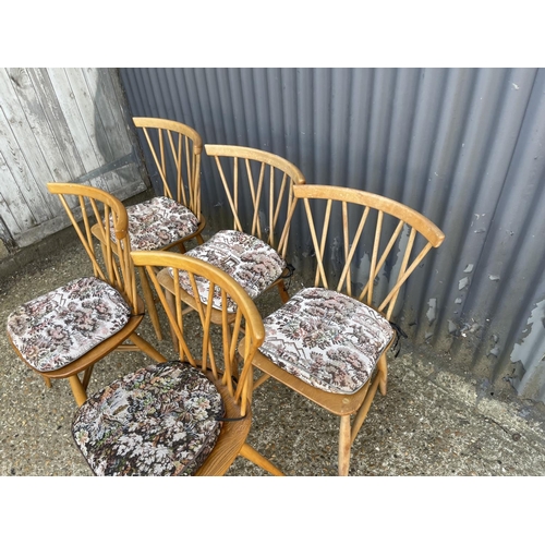 68 - A matched set of five Ercol stick back chairs (three with straight stretchers, two with cross cross ... 