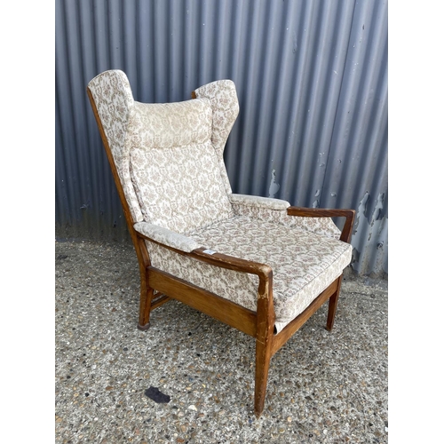 72 - A mid century wing back fireside chair