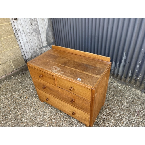 89 - A good quality Heals style oak chest of four drawers