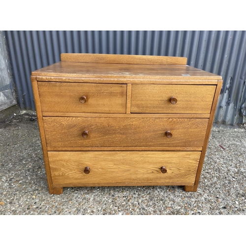 89 - A good quality Heals style oak chest of four drawers