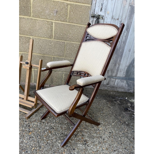 93 - A folding steamer style chair, easel and wooden steps