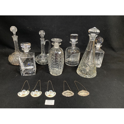 1054 - Seven glass Decanters, two Silver Labels and three Coalport labels