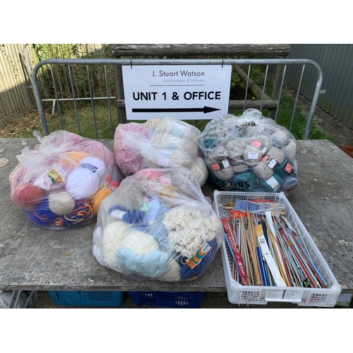 1061 - Four bags of knitting wool and tray knitting needles