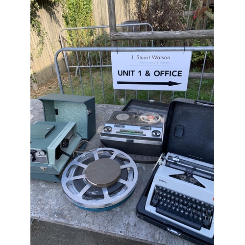 1081 - Argus projector, 3 film reels, Saba reel to reel player and Olympia typewriter