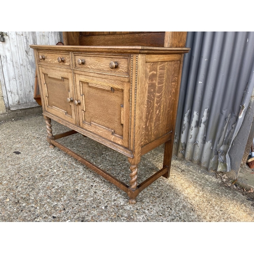 41 - An early 20th century oak dresser with plate rack back, two drawers and two doors