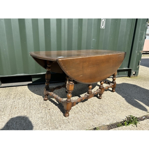 42 - A dark Ercol drop leaf coffee table