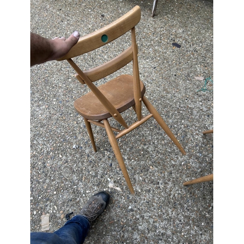 107 - A set of four ercol light elm stacking chairs