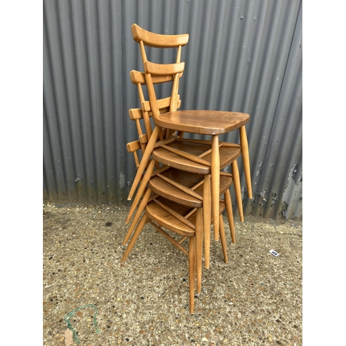 107 - A set of four ercol light elm stacking chairs