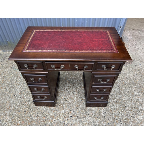 121 - A reproduction mahogany twin pedestal desk