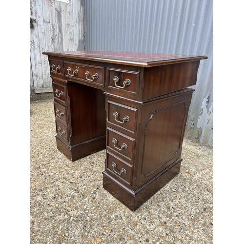 121 - A reproduction mahogany twin pedestal desk