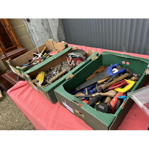 125 - Four trays of tools and fixings including wheelchair feet, tools, light lenses etc