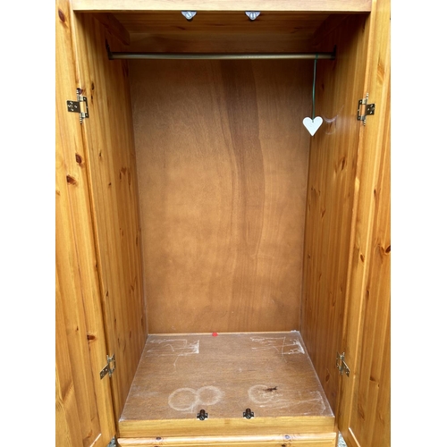 135 - A pine double wardrobe with two drawers 84x40x181