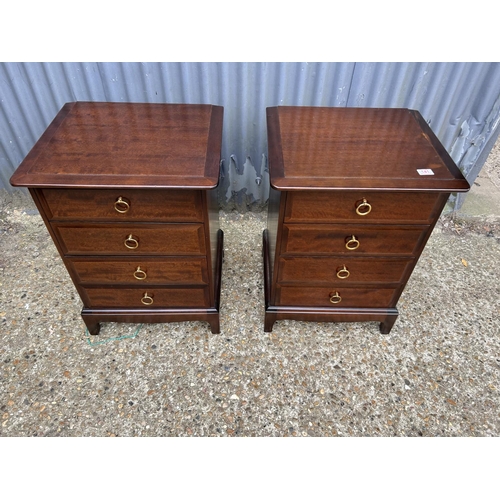 141 - A pair of stag four drawer bedside chests