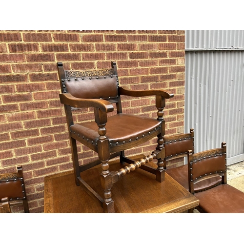 17 - An early 20th century oak drawer leaf dining table together with a set of five chairs