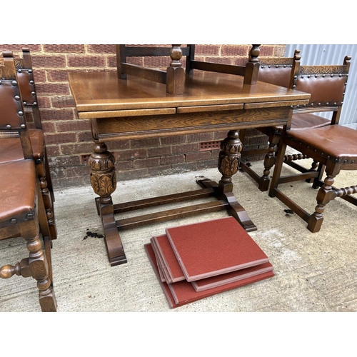 17 - An early 20th century oak drawer leaf dining table together with a set of five chairs