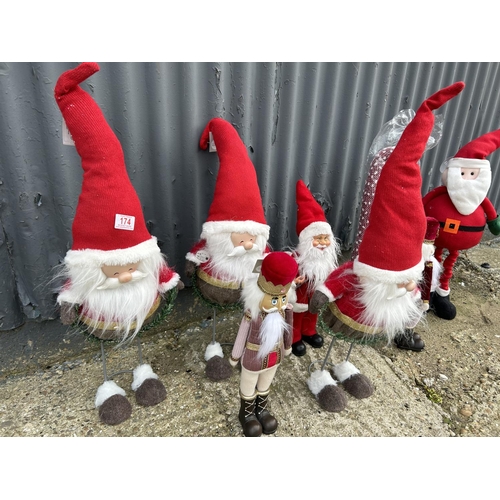 174 - A collection of 8 novelty Santa figures