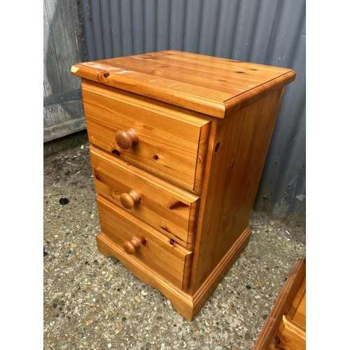 176 - A pair of solid pine bedside chests of three