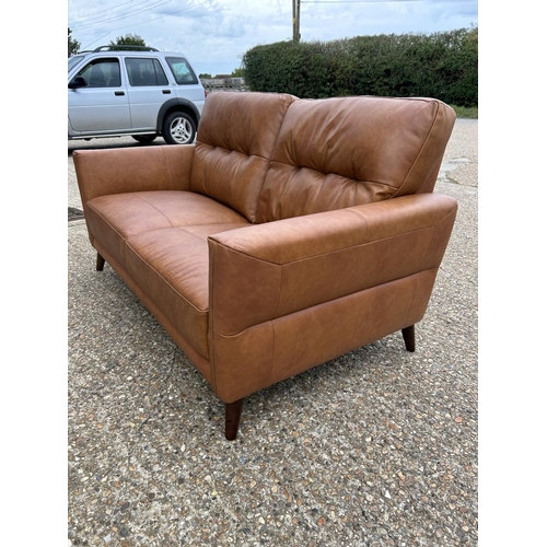 189 - A modern tan brown leather two seat sofa with adjustable head supports